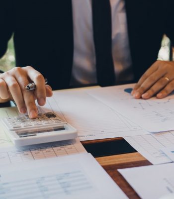 Businessmen are calculating the cost of the company's sales and