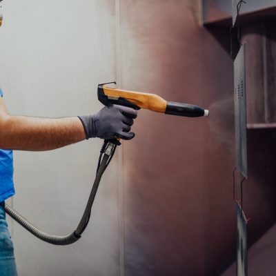 The painter paints the iron element. Industrial painting parts. Metal designs